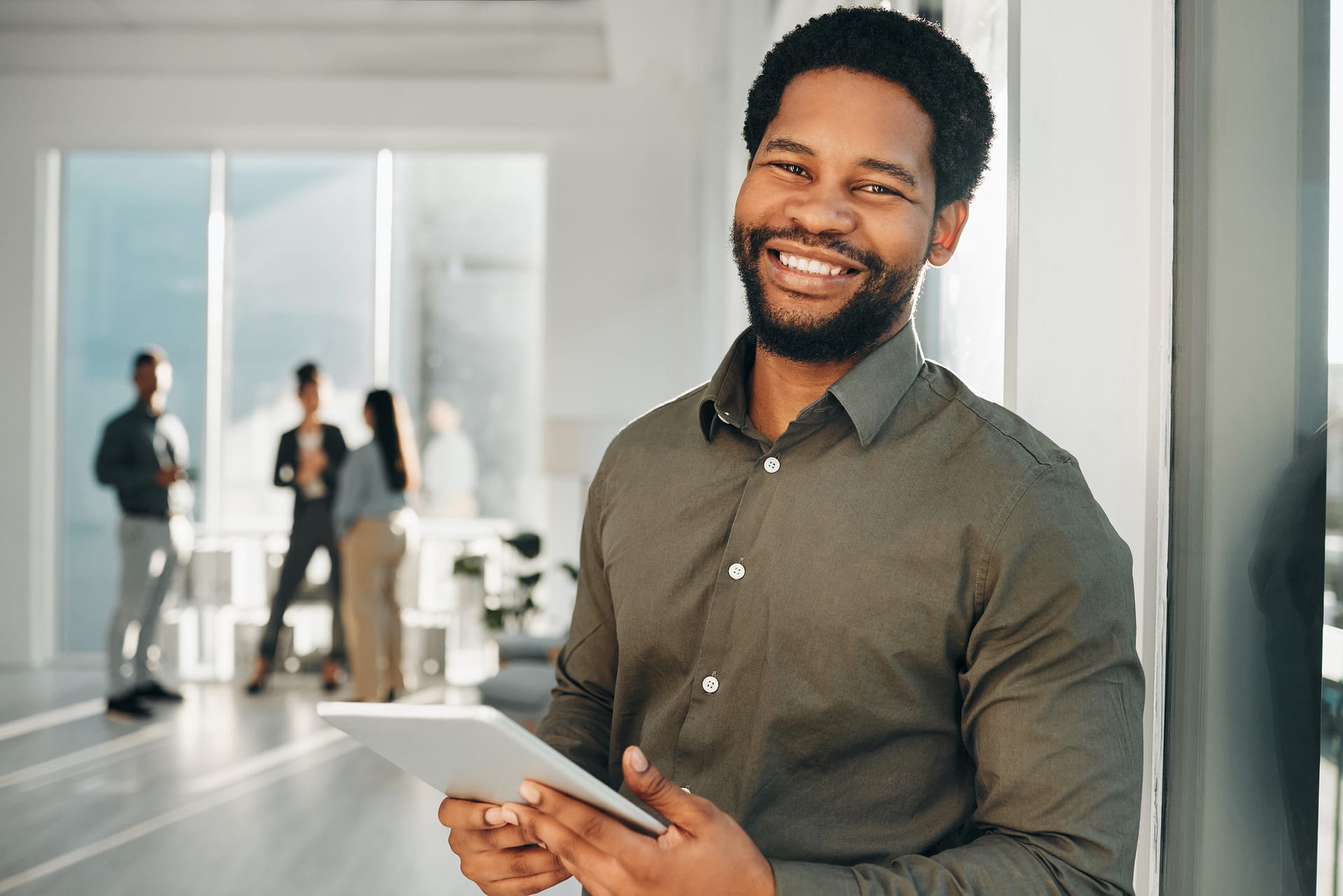 Portrait, digital tablet and businessman in office happy, smile and empowered, ambition and mindset. Face, vision and guy ceo at startup company for management, mission or online project at workplace